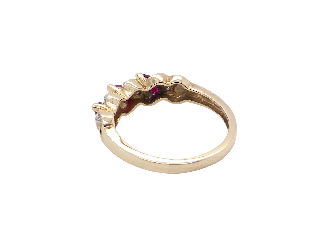 rear A pretty 9 carat gold dress ring. The three rubies are marquise cut, 5x3mm each, and set at an angle .