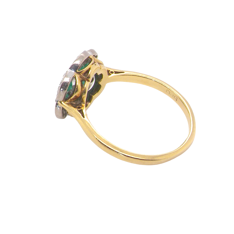 rear A pretty cluster ring. Features emeralds and diamonds. Centre stone a brilliant cut white diamond, measures 4mm (0.25 carats). 