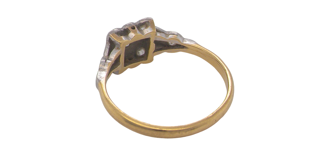 rear A pretty diamond cluster ring from the early part of the 20th century. A square head that has within it small white diamonds, measures 8x8mm, fancy shoulders also set with tiny diamonds.