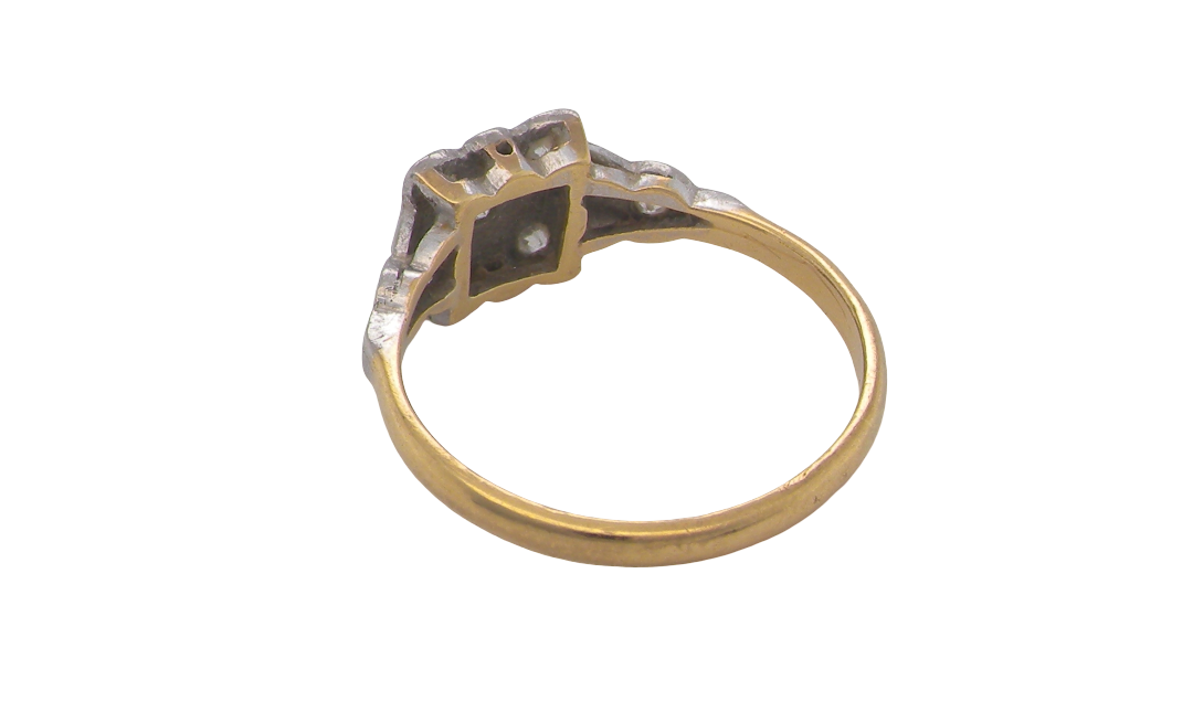 rear A pretty diamond cluster ring from the early part of the 20th century. A square head that has within it small white diamonds, measures 8x8mm, fancy shoulders also set with tiny diamonds.