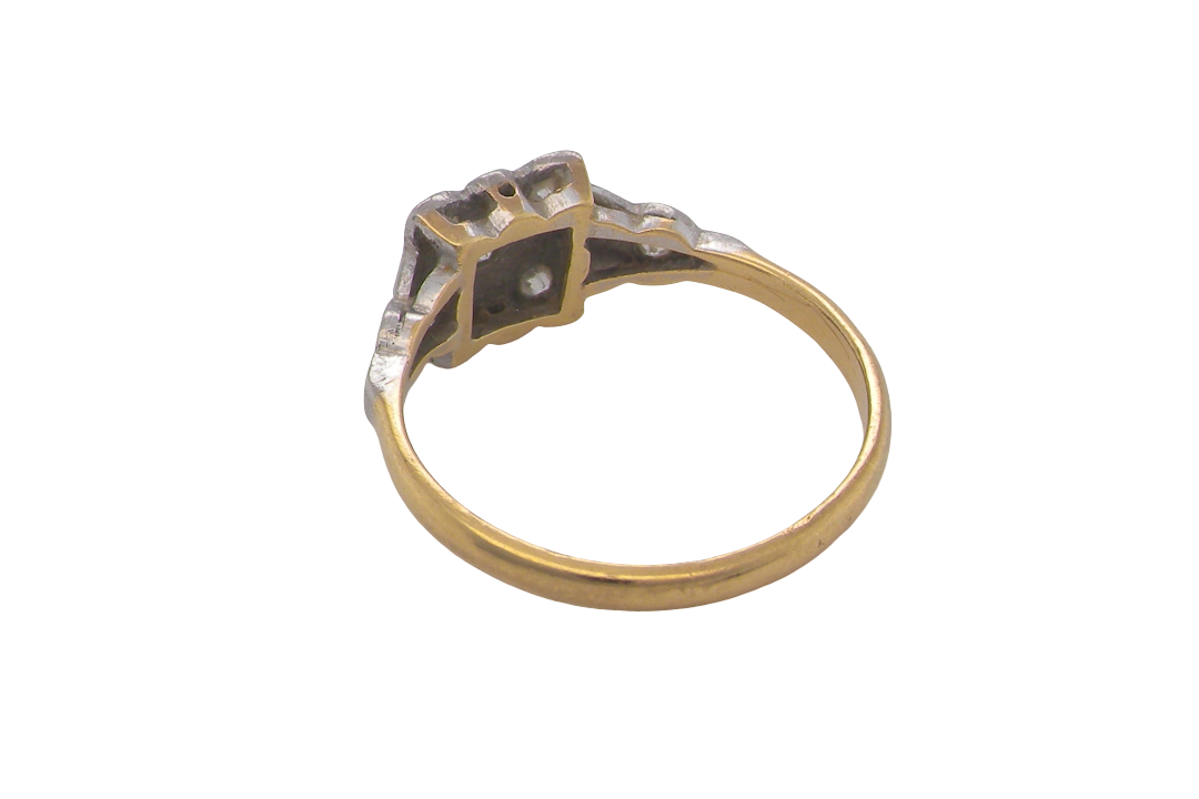 rear A pretty diamond cluster ring from the early part of the 20th century. A square head that has within it small white diamonds, measures 8x8mm, fancy shoulders also set with tiny diamonds.