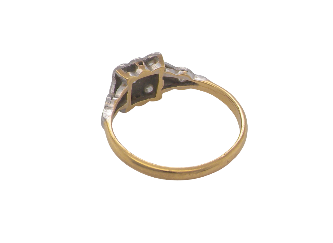 rear A pretty diamond cluster ring from the early part of the 20th century. A square head that has within it small white diamonds, measures 8x8mm, fancy shoulders also set with tiny diamonds.