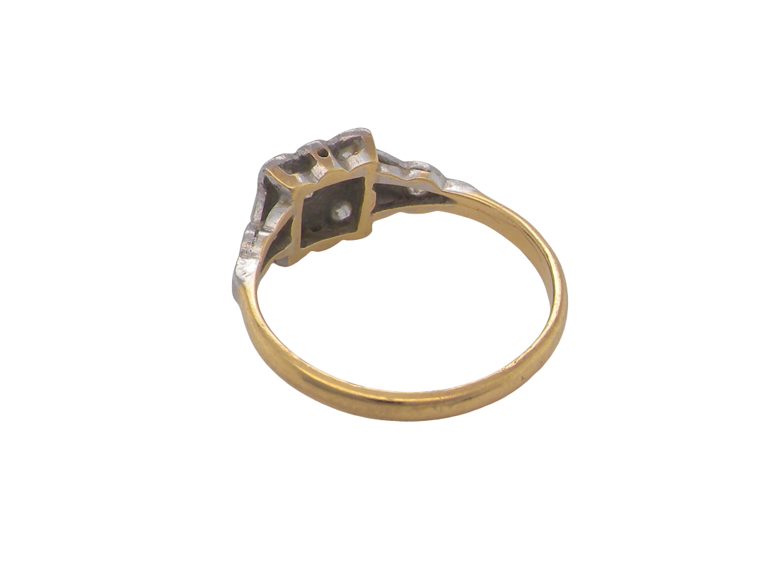 rear A pretty diamond cluster ring from the early part of the 20th century. A square head that has within it small white diamonds, measures 8x8mm, fancy shoulders also set with tiny diamonds.