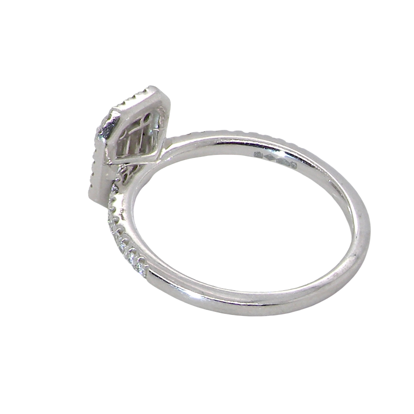 rear A rectangular diamond cluster ring. Centre portion is set with three baguette cut white diamonds 3x1.6mm and six mixed cut diamonds 2mm each.
Surrounded by a halo of twenty two small round diamonds
