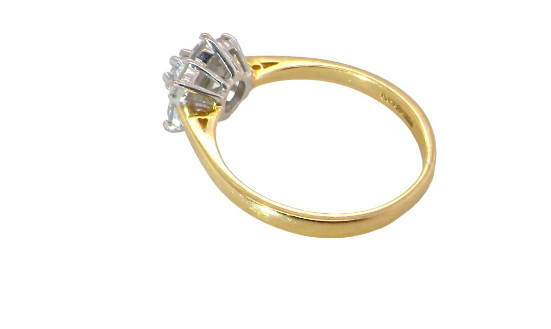 rear A small cluster ring set with seven bright white brilliant cut white diamonds.
Head measures 8.5mm, each diamond measures 2.8mm (total 0.50 carats