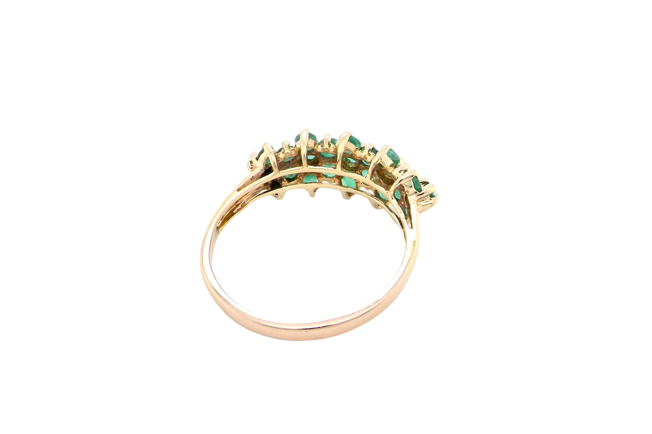 rear A striking and unusual dress ring, designed with multiple clusters of round-cut emeralds set beautifully across the finger for a bold, eye-catching look.