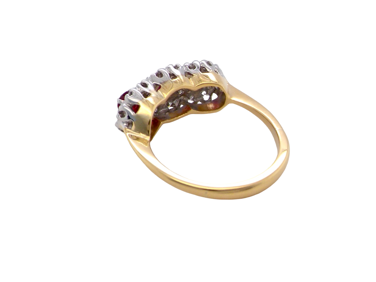 rear A striking  cluster ring crafted in 18 carat gold, dating circa 1990–2000, and fully hallmarked in the UK.
✨ Design & Gemstones
Three deep red rubies set to the centre of each cluster