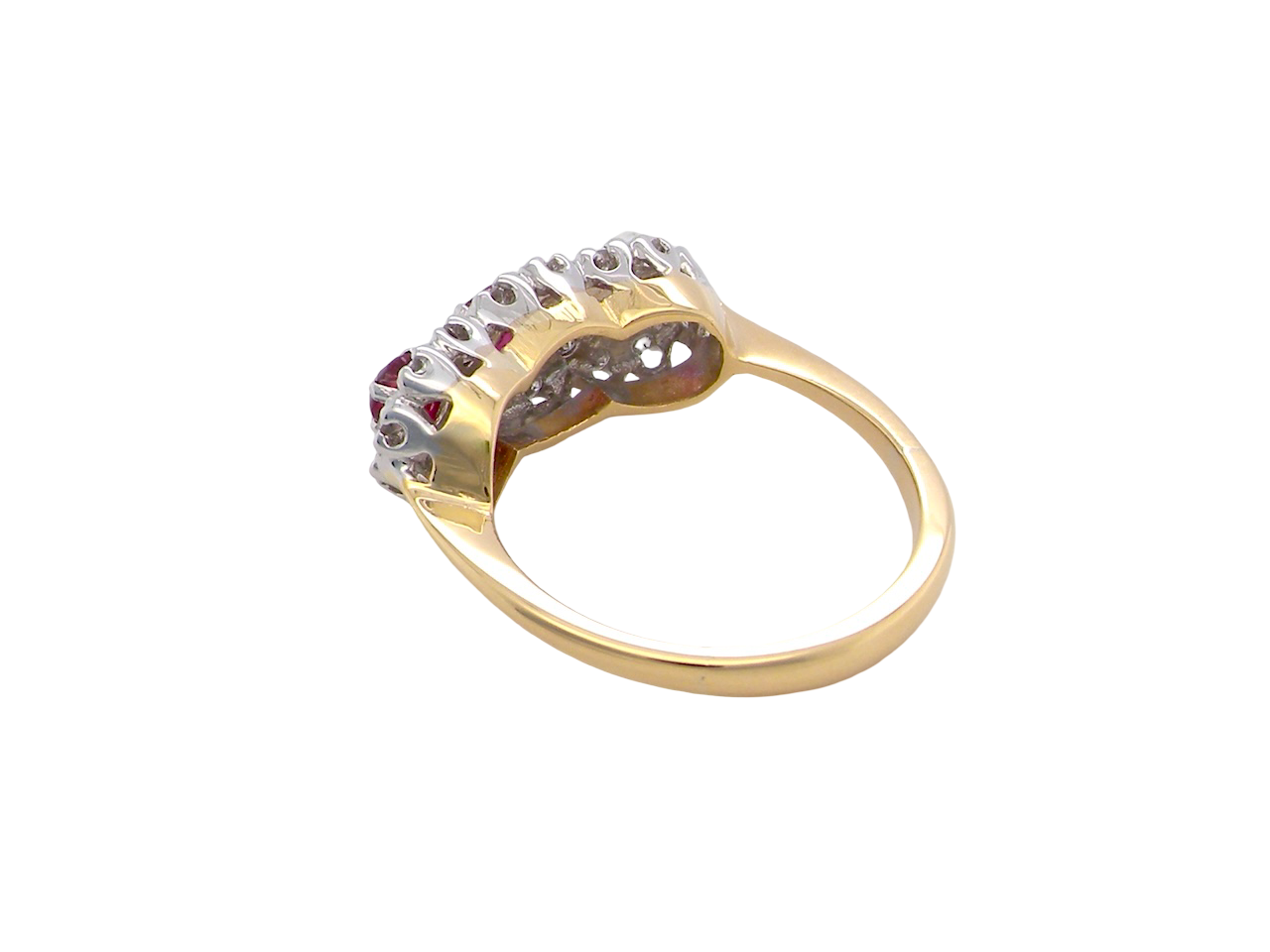 rear A striking triple cluster ring crafted in 18 carat gold, dating circa 1990–2000, and fully hallmarked in the UK.
✨ Design & Gemstones
Three deep red rubies set to the centre of each cluster