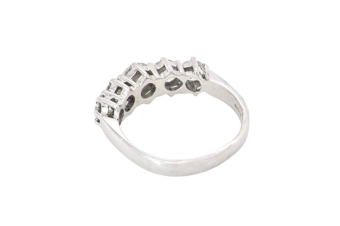 rear A stunning half hoop ring featuring five exceptional brilliant-cut white diamonds, expertly claw set in 18ct white gold.
The centre diamond measures approximately 5.8mm (estimated 0.70 carats), flanked by a 5.0mm diamond on each side, with 4.5mm diamonds at each end.