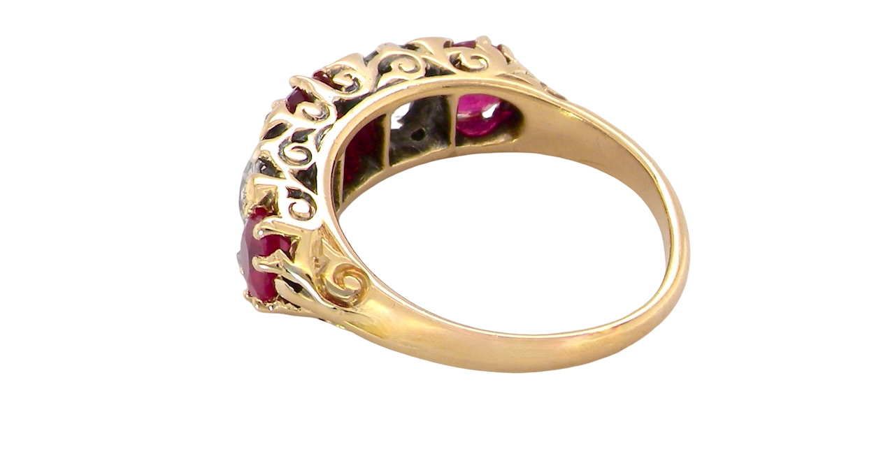 rear A superb Victorian ring, carved boat shaped head. Set with three fine rubies ,