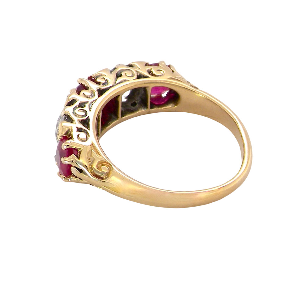 rear A superb Victorian ring, carved boat shaped head. Set with three fine rubies ,