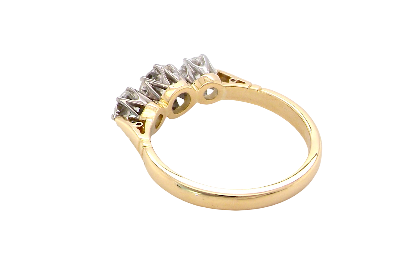 rear A three stone trilogy ring. The diamond centre stone measures 5.5mm (est 0.60 carats) each side a 4mm diamond , total estimated at 1.10 carats.