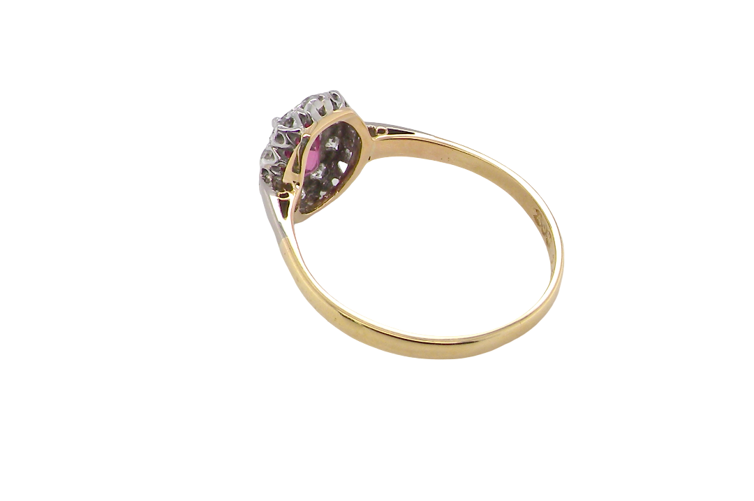 rear A traditional cluster ring. Features to the centre a dark pink red ruby, oval cut 6x4mm (0.50 carats)
