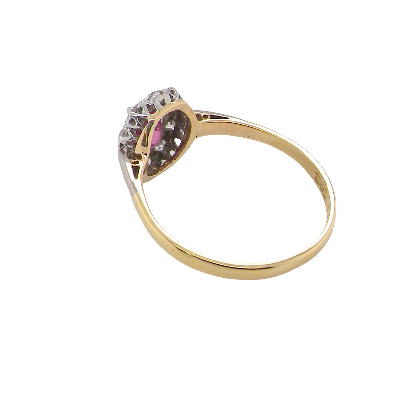 rear A traditional cluster ring. Features to the centre a dark pink red ruby, oval cut 6x4mm (0.50 carats)