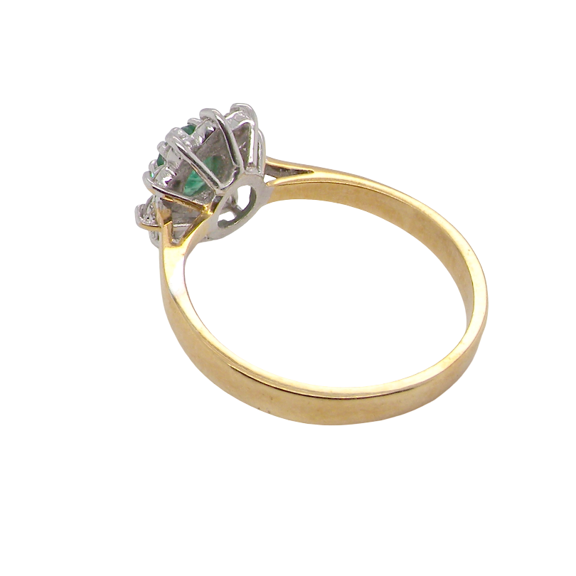 rear A traditional cluster ring. Features to the centre an oval shaped emerald, 5.5x4.5mm (est 0.35 carats) deep green colour. 
