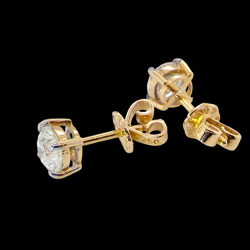 A pair of yellow gold stud earrings with round-cut clear gemstones in a halo setting, shown from multiple angles against a solid black background.