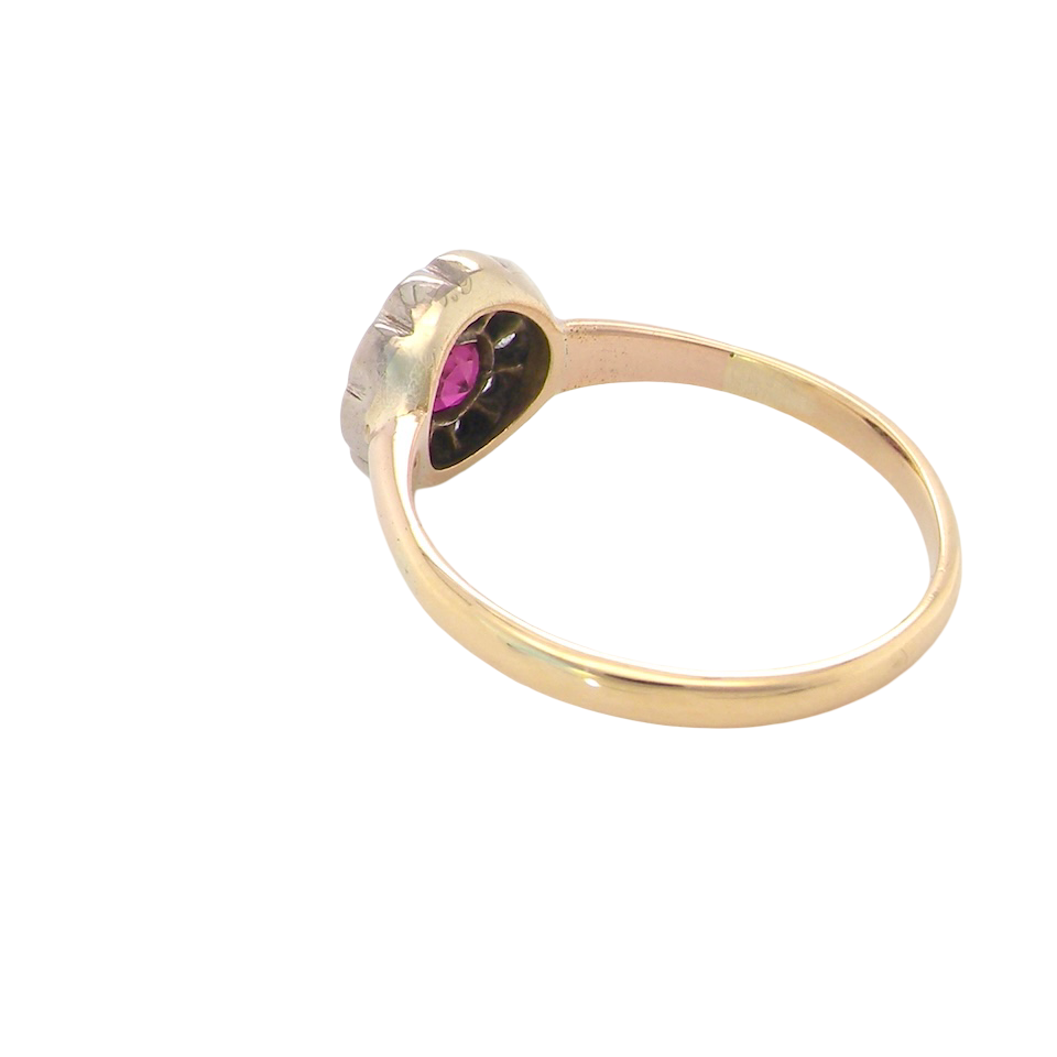 rear A very pretty vintage daisy cluster ring. Features to the centre a round pink red ruby that measures 4mm, and is mille grain set.