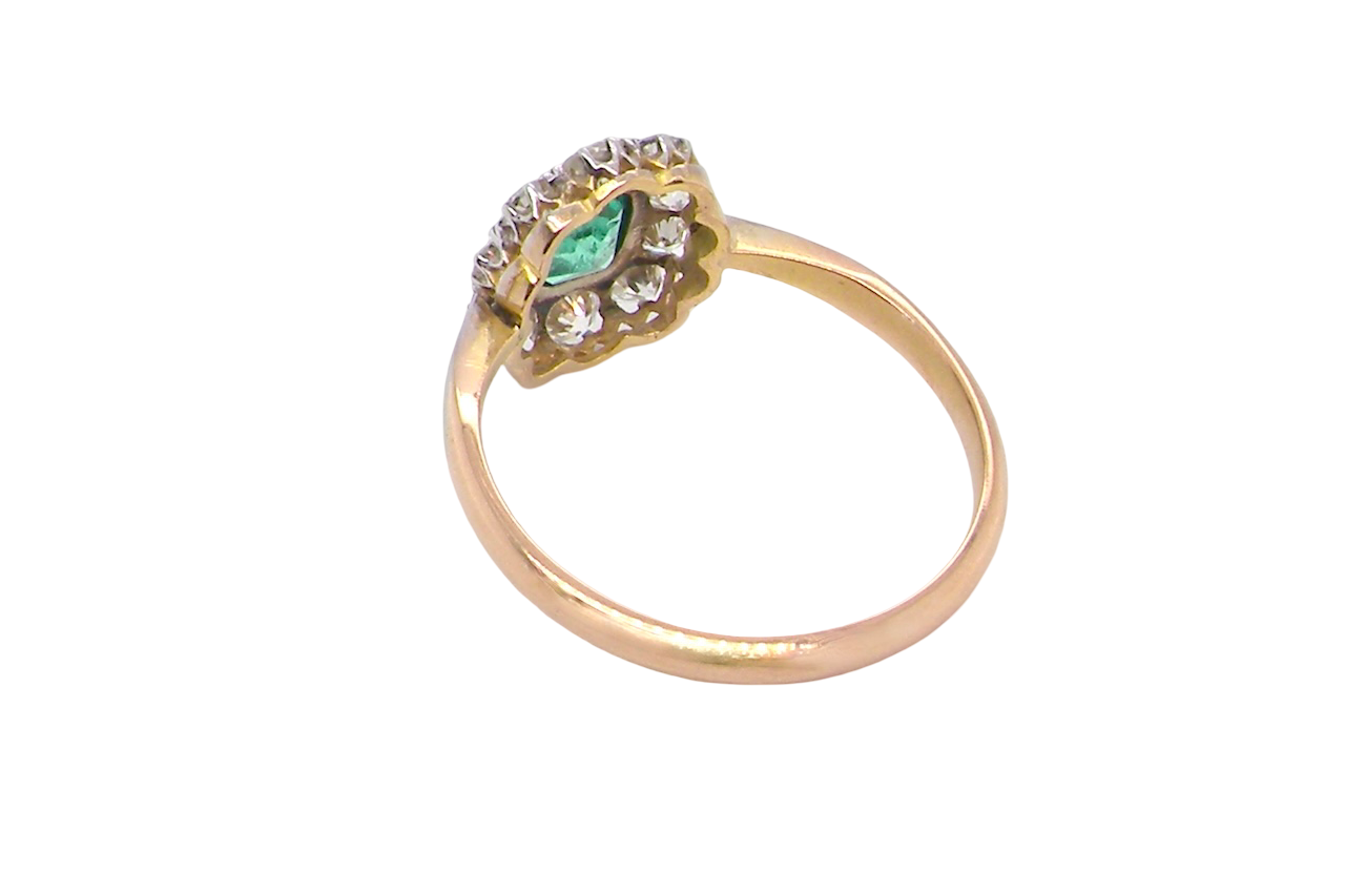 rear A vintage cluster ring, the centre stone a cushion shaped emerald 4x3.5mm, mid to dark green colour. Mille grain setting.