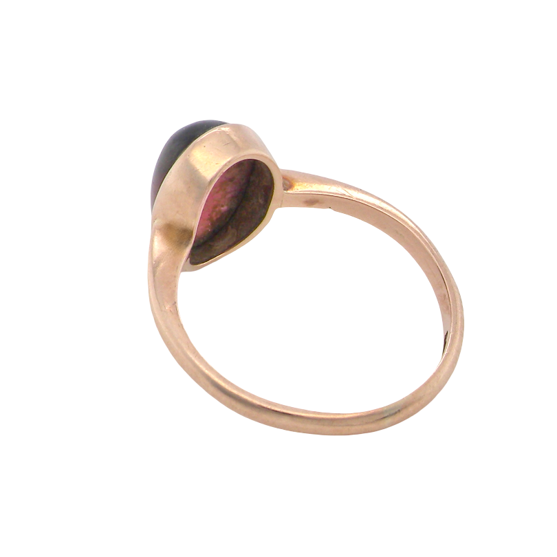 rear A vintage dress ring. Set with an oval cabouchon cut garnet, 11x7mm, in a rim style setting.