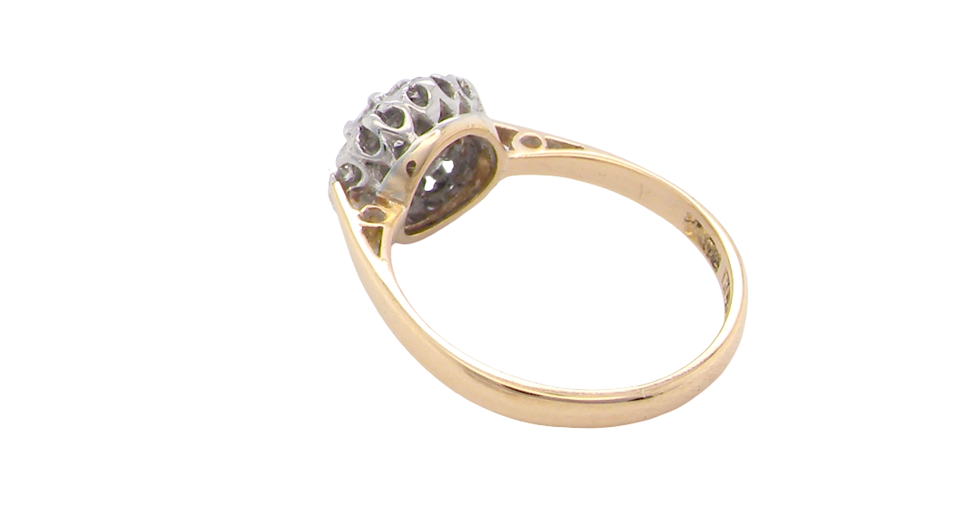 rear A vintage mid 20th century cluster ring. Principle stone a brilliant cut white diamond, 4mm (0.25 carats est) clarity i-j, clarity Si.