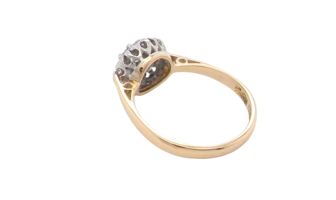 rear A vintage mid 20th century cluster ring. Principle stone a brilliant cut white diamond, 4mm (0.25 carats est) clarity i-j, clarity Si.