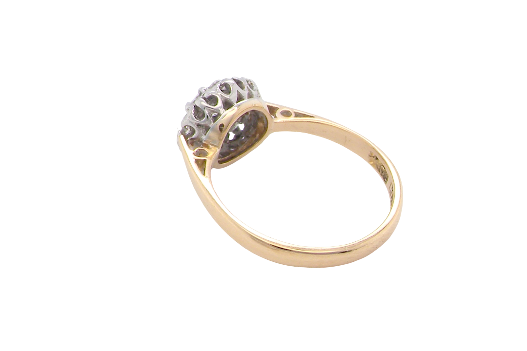 rear A vintage mid 20th century cluster ring. Principle stone a brilliant cut white diamond, 4mm (0.25 carats est) clarity i-j, clarity Si.