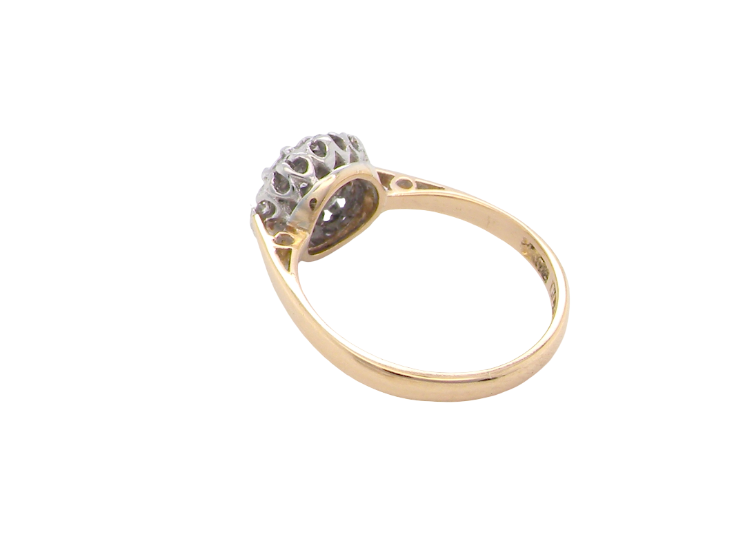 rear A vintage mid 20th century cluster ring. Principle stone a brilliant cut white diamond, 4mm (0.25 carats est) clarity i-j, clarity Si.