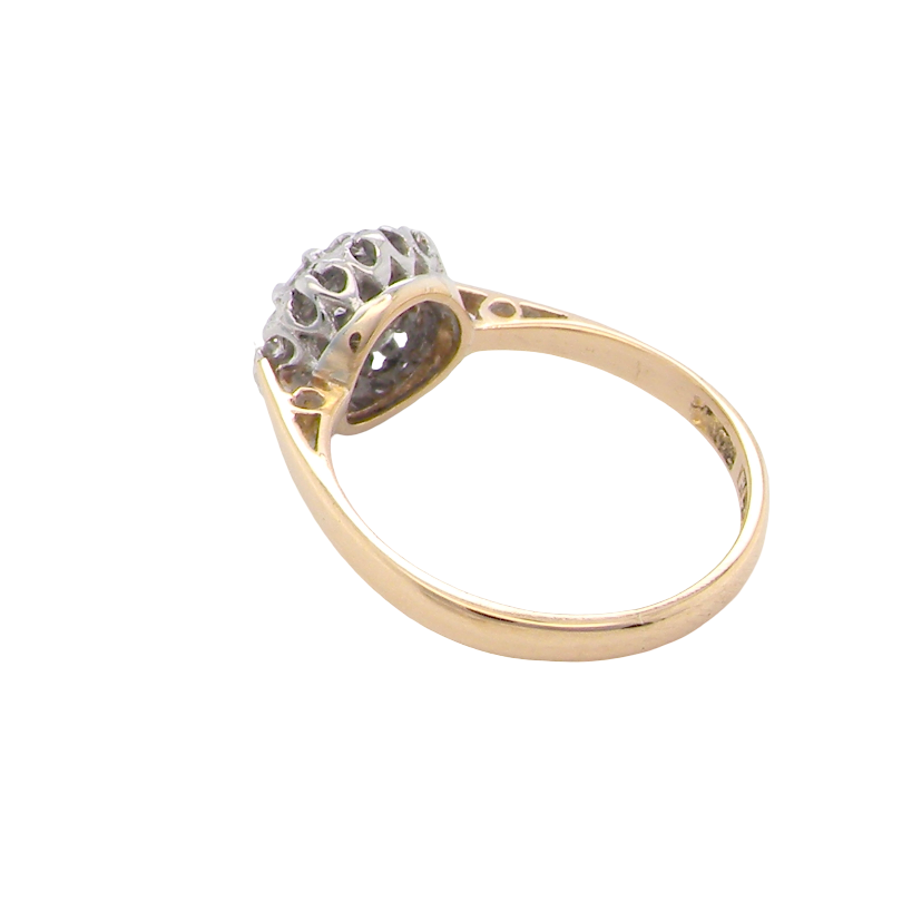 rear A vintage mid 20th century cluster ring. Principle stone a brilliant cut white diamond, 4mm (0.25 carats est) clarity i-j, clarity Si.