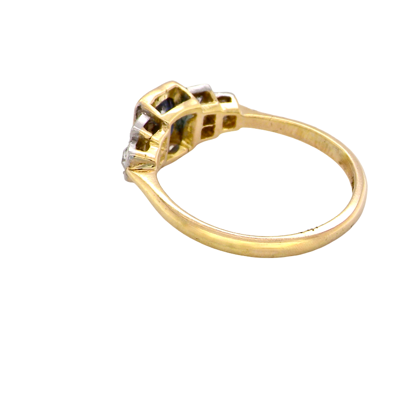 rear A vintage ring that features to the centre a substantial sapphire and to each side set in platinum three small diamonds.