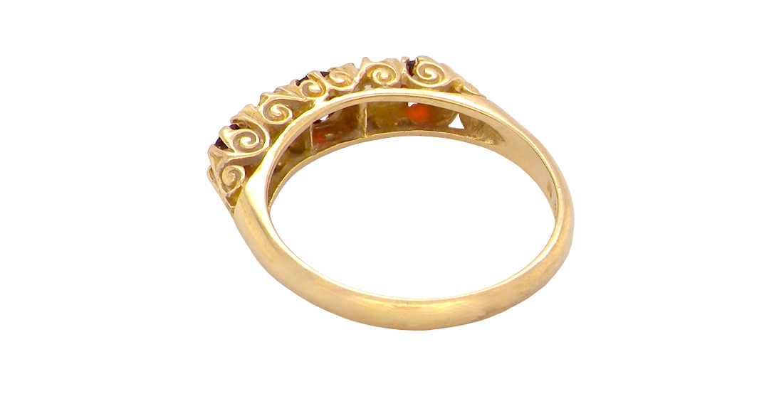 rear A vintage style 18 carat gold boat shaped ring. Features three dark red garnets, centre 4mm, each end a 3mm stone. 
