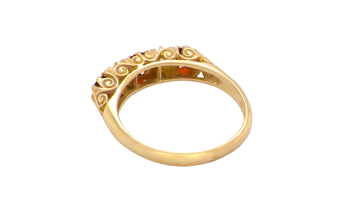 rear A vintage style 18 carat gold boat shaped ring. Features three dark red garnets, centre 4mm, each end a 3mm stone. 