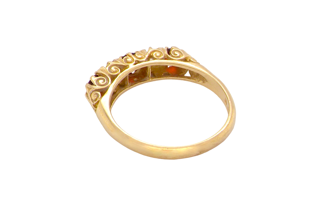 rear A vintage style 18 carat gold boat shaped ring. Features three dark red garnets, centre 4mm, each end a 3mm stone. 