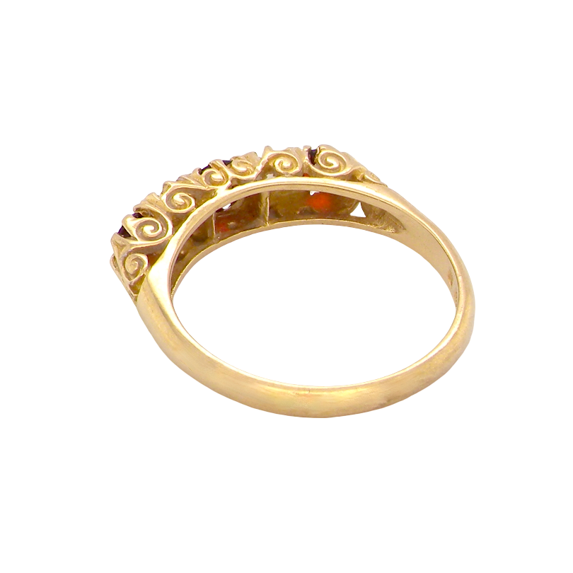 rear A vintage style 18 carat gold boat shaped ring. Features three dark red garnets, centre 4mm, each end a 3mm stone. 