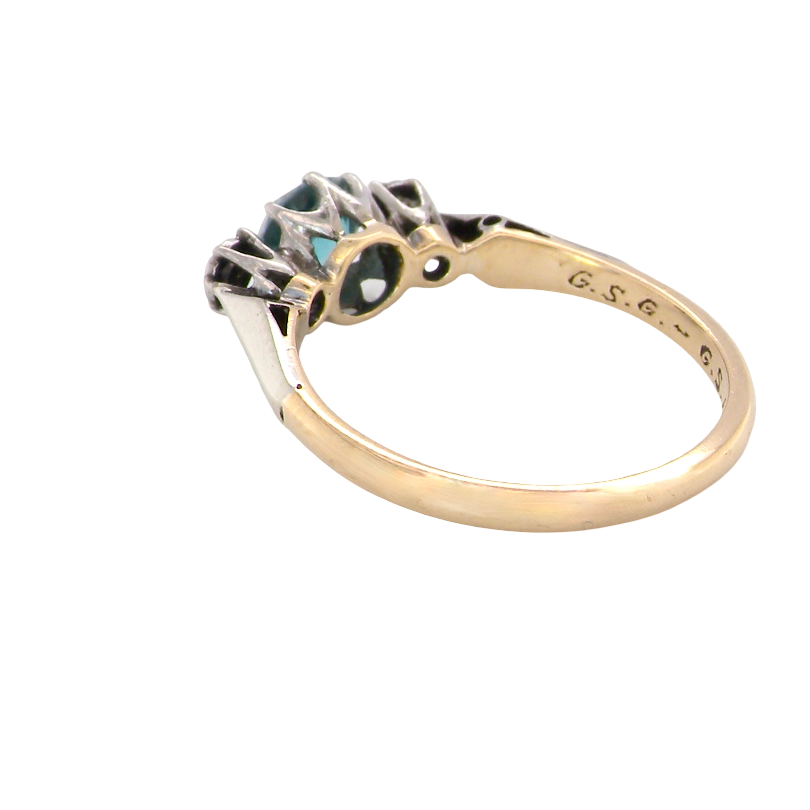 rear A vintage three stone ring. Features to the centre a 6mm natural blue zircon, 6mm diameter, claw set.