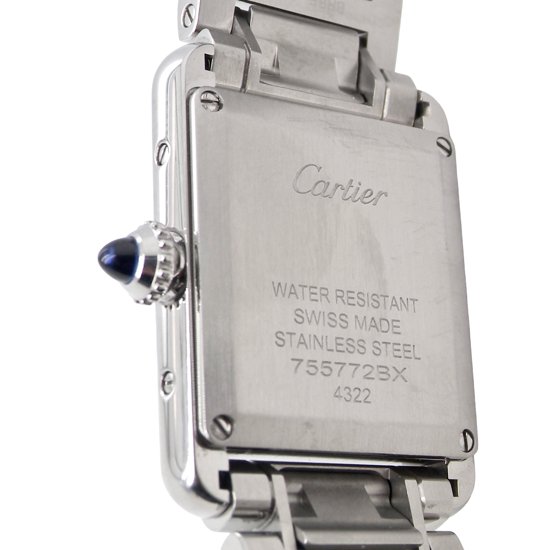 rear A womans stainless steel Cartier Tank Must wrist watch. Model number WSTA0051.
Silver coloured dial with Roman Numerals. Blue steeled hands. Case measures 29.5x22mm, case thickness 6.6mm. Quartz movement, synthetic sapphire button.
