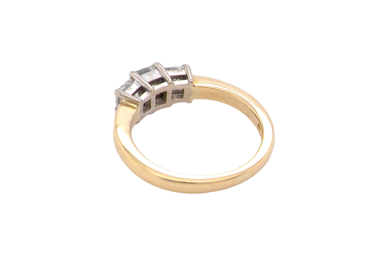 Gold ring with diamond accents on a white background