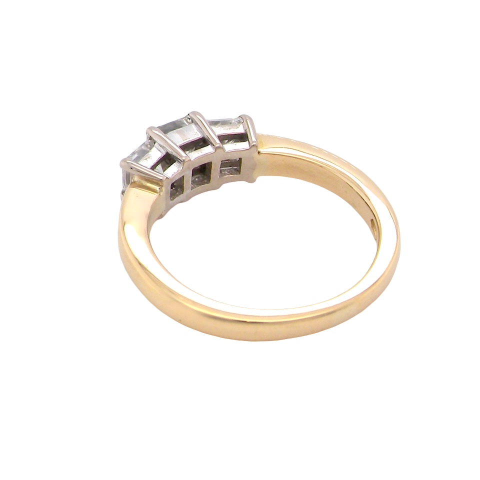 Gold ring with diamond accents on a white background