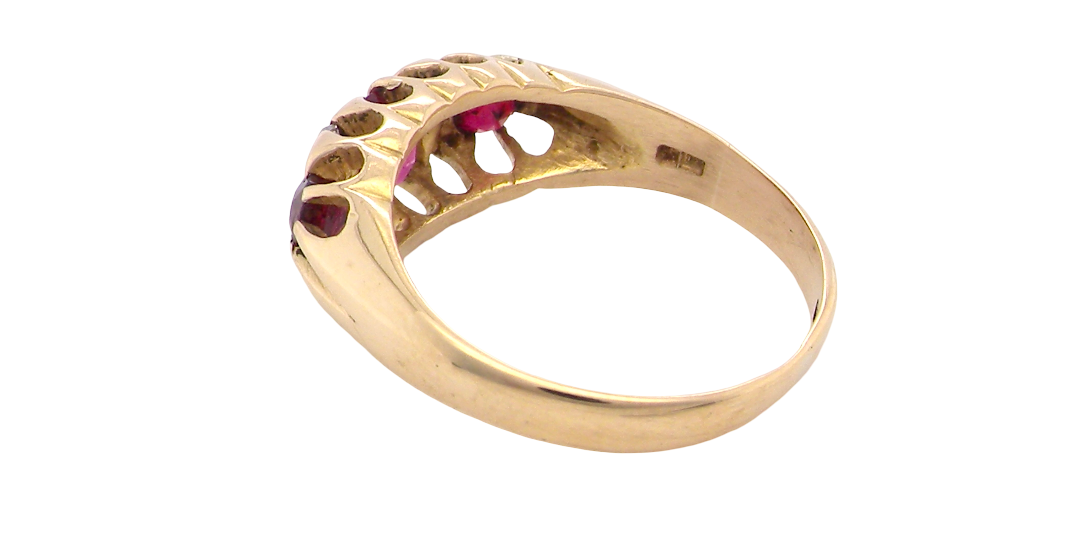 rear An 18 carat gold antique boat shaped ring. Features three lovely coloured wine red rubies, centre 5x4mm, each end 2.4mm.