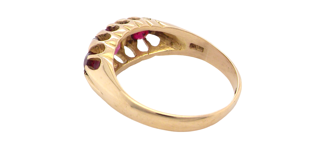 rear An 18 carat gold antique boat shaped ring. Features three lovely coloured wine red rubies, centre 5x4mm, each end 2.4mm.