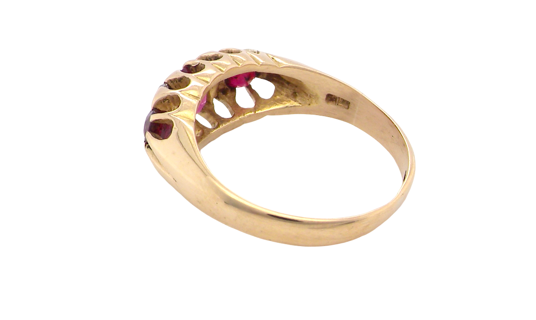 rear An 18 carat gold antique boat shaped ring. Features three lovely coloured wine red rubies, centre 5x4mm, each end 2.4mm.