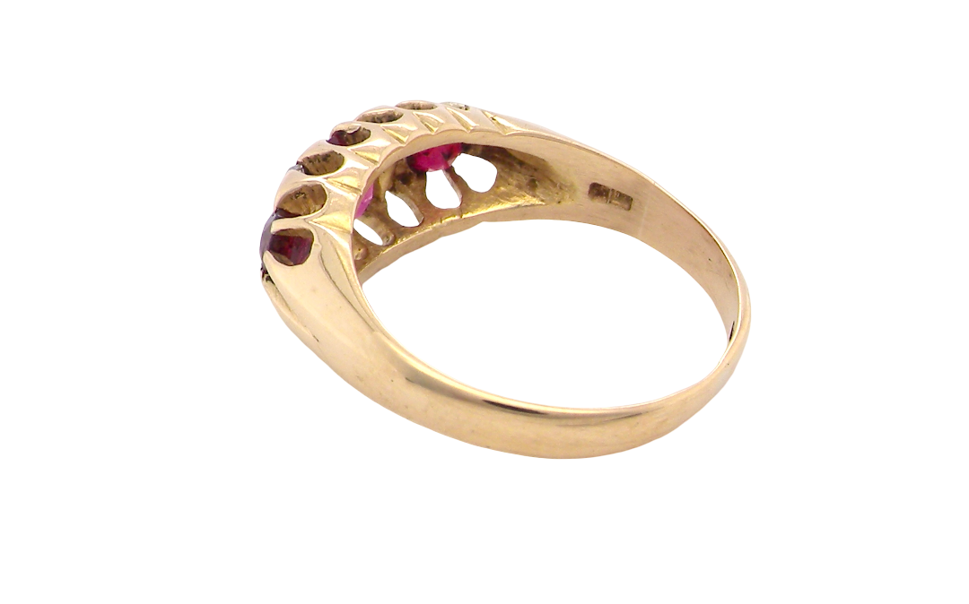 rear An 18 carat gold antique boat shaped ring. Features three lovely coloured wine red rubies, centre 5x4mm, each end 2.4mm.