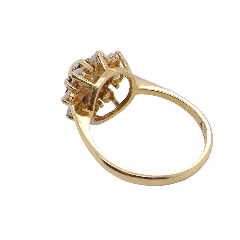 rear An 18 carat gold cluster dress ring. Features top the centre a white opal 4.7mm diameter, surrounded by an inner halo of eight 2mm sapphires, then an outer halo of eight 2.2mm opals.