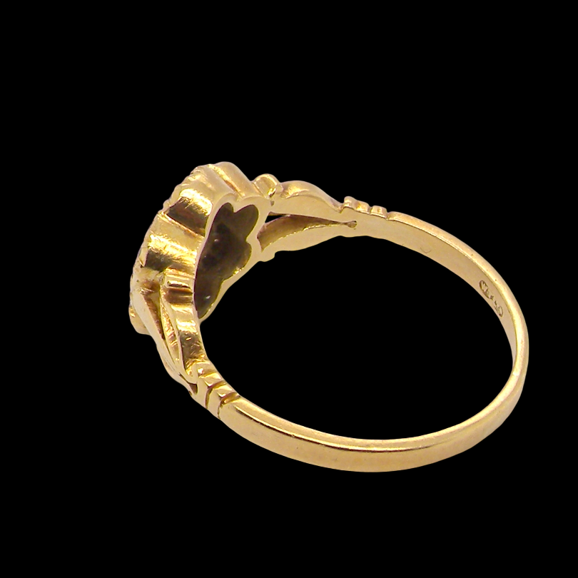 rear An 18 carat gold cluster ring. The centre a floral combination of seven sapphires, each 2.5mm, mid to dark blue.