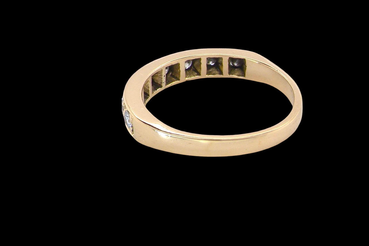 rear An 18 carat gold half-hoop eternity ring, set with eight brilliant-cut white diamonds