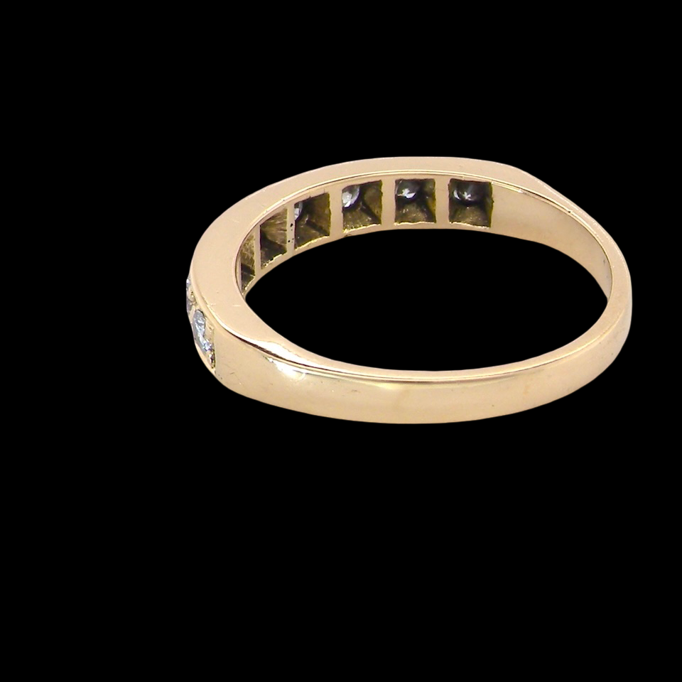 rear An 18 carat gold half-hoop eternity ring, set with eight brilliant-cut white diamonds
