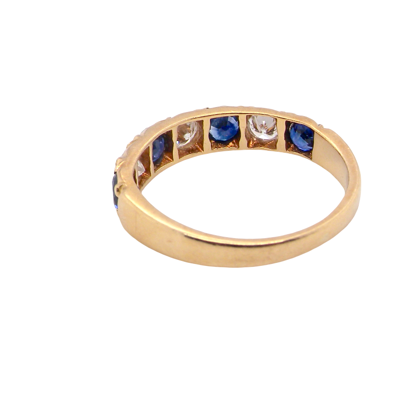 rear An 18 carat gold half hoop eternity ring. Set with four sapphires each 3.4mm (0.15 carats) and three diamonds, brilliant cut, 3.4mm (0.15 carats).