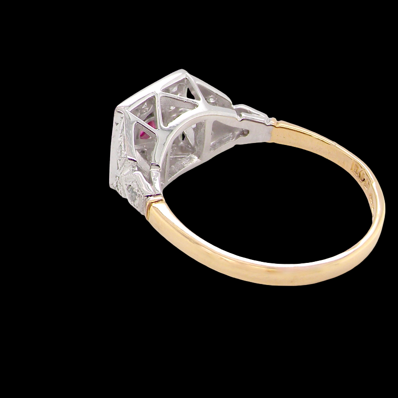 rear An 18 carat gold square cluster that features to the centre a round ruby and an outer halo of brilliant cut white diamonds.