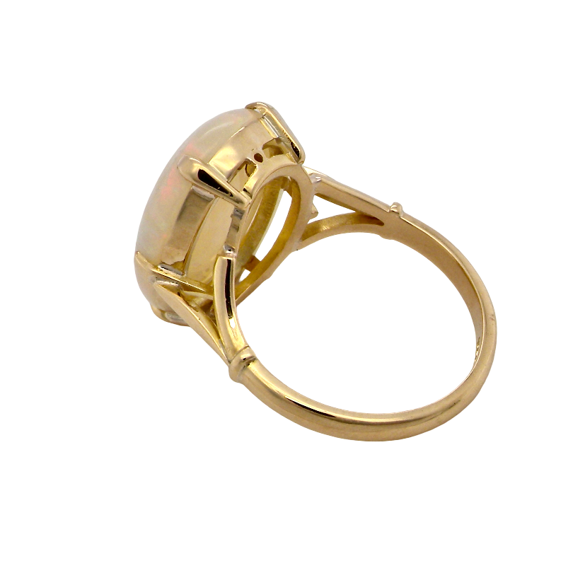 rear An 18 carat yellow gold* dress ring set with a large oval opal gemstone.