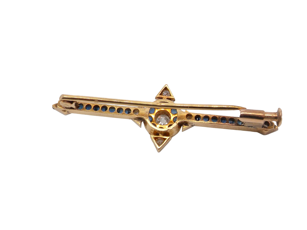 rear An Edwardian bar brooch. The centre 'target' style portion is set with a brilliant cut white diamond 4mm (0.25 carats) colour H-j, clarity Si. Mille grain setting.