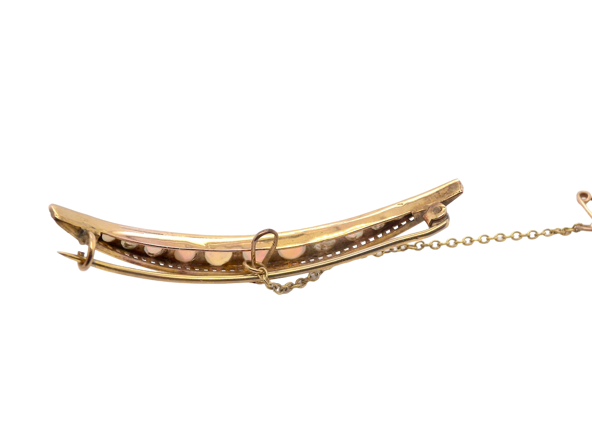 An Edwardian opal crescent shaped brooch